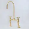 Vintage patina brass bridge kitchen faucet with curved legs and cross handles