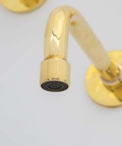 Wall-mounted tub filler with sleek design and brass finish for freestanding bathtubs