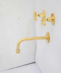 Wall-mounted tub filler with sleek design and brass finish for freestanding bathtubs